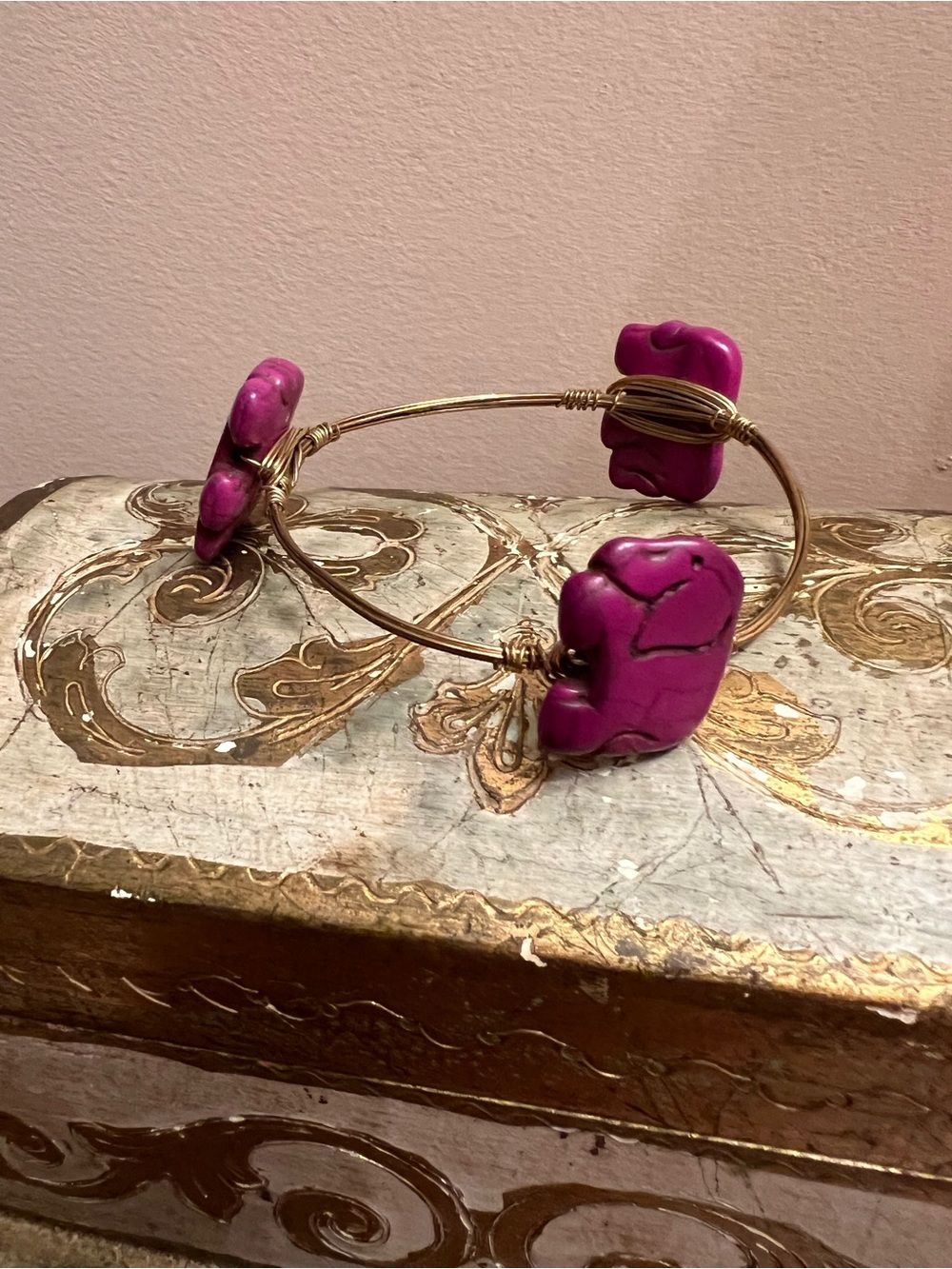 Gold-Tone Wire Bangle Bracelet with Magenta Dyed Howlite Elephants